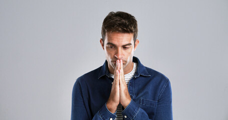 Man, prayer hands and stress in studio with faith, questions and hope for depression by background....