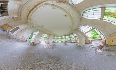 Panoramic view capturing the decaying Sanatorium Metallurgist in Tskaltubo, Georgia, featuring arched windows, debris-strewn floors, and remnants of a grand interior
