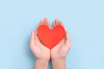 Obraz premium Hands Holding a Paper Red Heart Shape Top view Isolated On Blue Backdrop