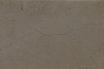 This closeup image highlights a cracked concrete surface, showcasing its unique texture and imperfections, ideal for construction and design applications with a raw, industrial look