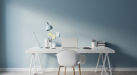 Minimalist workspace featuring a white desk, laptop, and a light blue lamp against a blue wall.