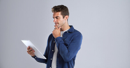 Online, tablet and man with thinking in studio for website update, app download and solution....