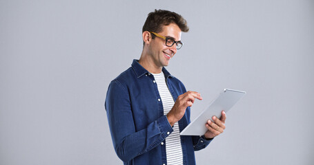 Glasses, smile and tablet with man in studio for programming or software development career. App,...