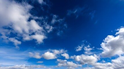 Obraz premium Clear blue sky with scattered white clouds, a serene and boundless horizon