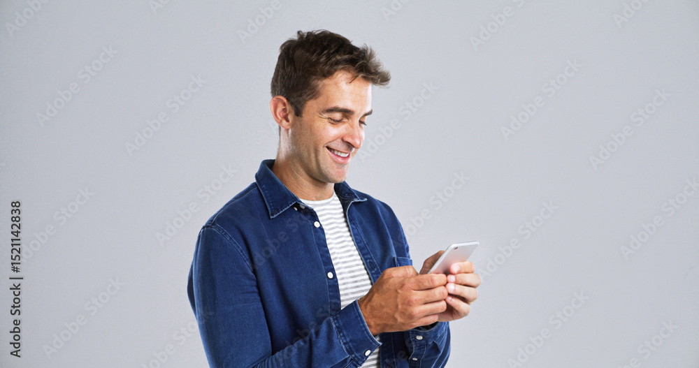 Poster smile, mobile and man in studio for typing, text or reading message on white background. phone, happ