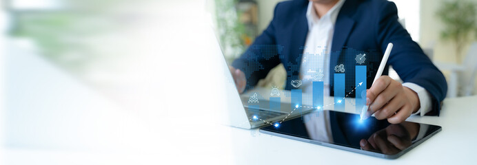 Business growth strategy concept. A professional uses a digital tablet to interact with blue bar graphs and business strategies icons; teamwork, innovation, business collaboration, sustainability.
