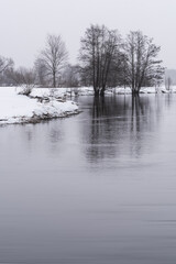 Winter Landscape Belarus. River in the Forest covered with Snow