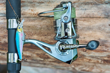 Close-up of spinning rod with reel and wobbler for fishing. Fishing tackle. Selective focus