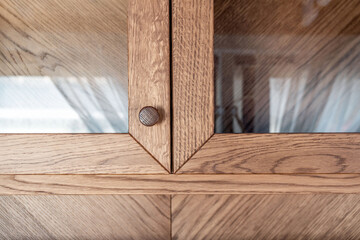 Beautifully crafted oak timber cabinet with glass fronts and intricately designed wooden knobs...