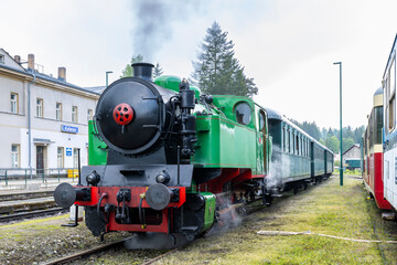 Fototapeta premium Vintage steam train departing from Korenov station in Czechia, Liberecky kraj