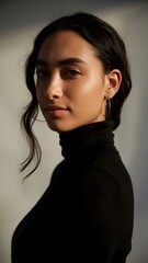 Fototapeta premium Intimate Portrait: A captivating young woman with long dark hair is captured in a striking portrait. Her poised expression and gentle gaze reveal a sense of calm confidence, accentuated by soft.