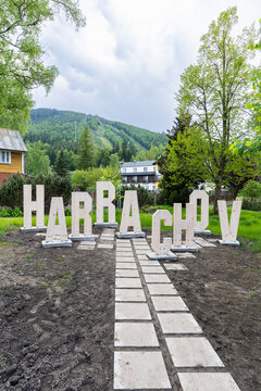 Harrachov sign with Certova hora mountain in background, Czechia