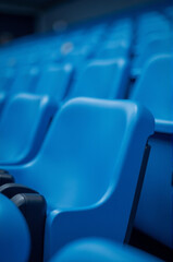 Rows of blue seats in a stadium, suitable for sports or concert events