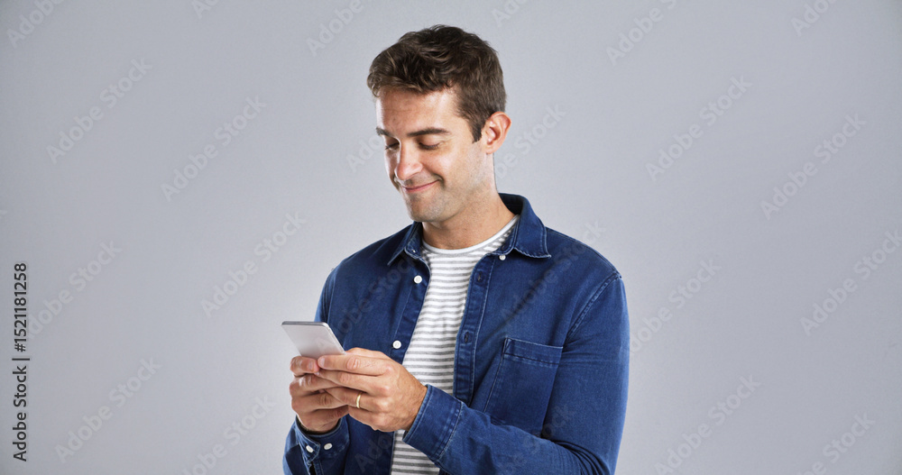 Poster smile, phone and man in studio for typing, text or reading message on white background space. mobile
