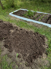 Setting up two high raised beds with wooden base.