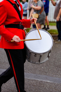 Young female drummer playing in local band during ANZAC day parade march