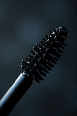 Close-up shot of a black mascara brush with bristles visible