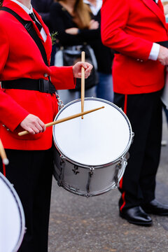 Young female drummer playing in local band during ANZAC day parade march