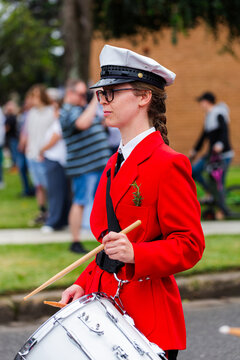 Young female drummer playing in local band during ANZAC day parade march