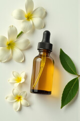 A bottle of essential oil sits next to a few white flowers, ideal for use in aromatherapy or as a decorative accent