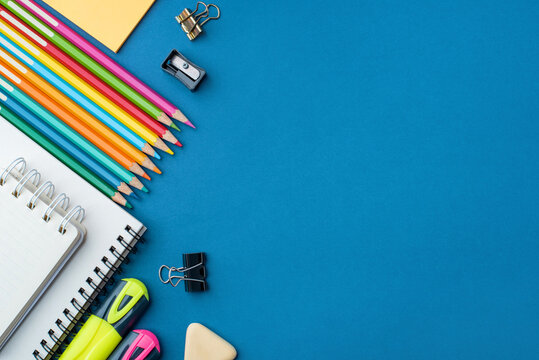 Bright school supplies on a blue background. The back to school concept