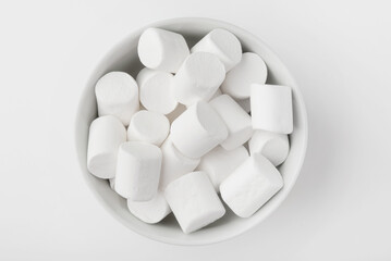 Ceramic bowl with marshmallows on a white backgroundd