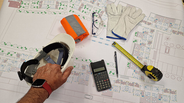PPE safety equipment, helmet, gloves, goggles, vest for construction workers, architectural plans epis