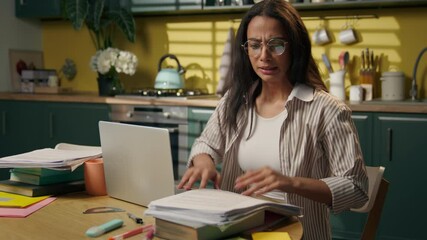 Hispanic woman student anxious stressed studying throwing papers mess at home kitchen Latina teen girl businesswoman laptop working remote searching documents messy paperwork stress problem deadline - Powered by Adobe