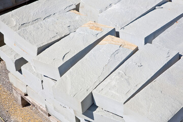 New sandstone slabs ready to be mounted in a new pavement in a urban construction site