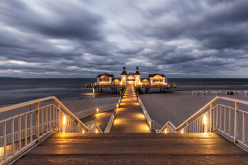 Illuminated historic pier at Ostseebad Sellin, Rügen, Germany, at night, long exposure
