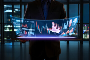 Businessman analyzing stock market data with futuristic technology interface