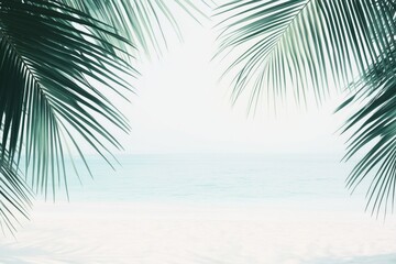 A serene view of a tropical beach framed by palm leaves.