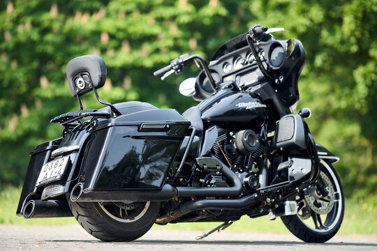 Minsk, Belarus - June, 4 2025: Harley-Davidson HD Street Glide Twin Cam 103 motorcycle selective focus over green foliage background