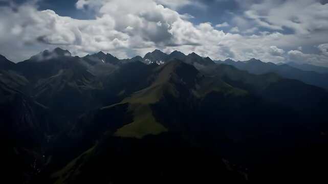 Misty Mountain Peaks Seen from Above with Clouds and Deep Valleys