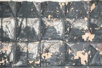 Peeling paint on an old wall reveals layers of history and texture in an abandoned building