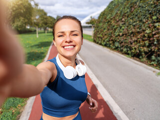 Urban fit woman taking selfie during her street workout in summer.