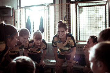 Girls soccer team getting ready in locker room before game