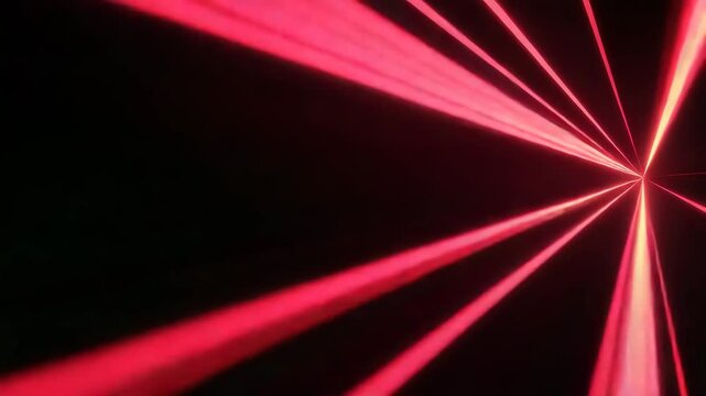 Red laser beams radiate and cross in dark space, creating dynamic energy pattern with bright glowing light that radiates vibrant red beam effects and intense glow