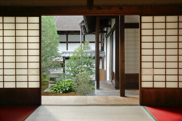 Interior of a traditional japanese house with sliding doors and view on a japanese garden