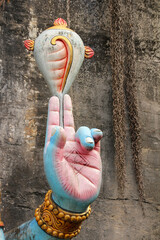 Close-up of Hindu god Vishnu's hand holding sacred conch shell (Shankha), divine attribute, Indian...