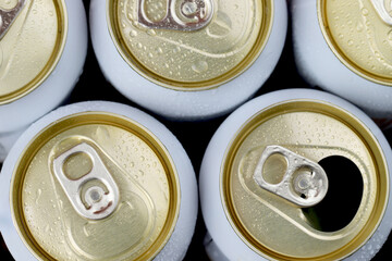 Cold canned beer ready to drink in the fridge.