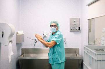 Healthcare worker in hospital setting engaged in professional task using medical equipment