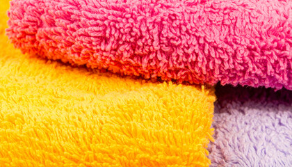 Soft Textured Towels: A close-up shot showcases the inviting textures and vibrant colors of neatly arranged towels. The image creates a sense of comfort and luxury.