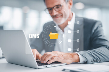 Businessman using Document Management System DMS on laptop for digital file management.