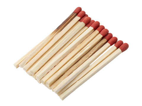 Close up shot showing a group of wooden matches with red tips arranged on a dark background