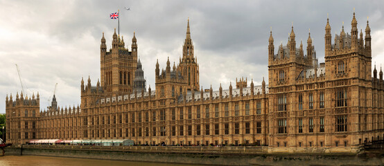 Panoramic View of Houses of Parliament on the River Thames with Union Jack Flag flying proudly. It has recently been renovated and is looking fresh and clean