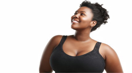 Studio shot of a beautiful plus size black woman wearing a sports bra, smiling and looking up, expressing confidence and body positivity, isolated on a transparent background