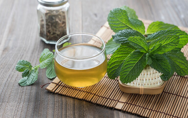 mint leaves and a glass of mint tea on the table