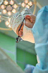 The surgeon is working hard in the operating room