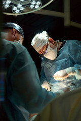 The surgeon is working hard in the operating room